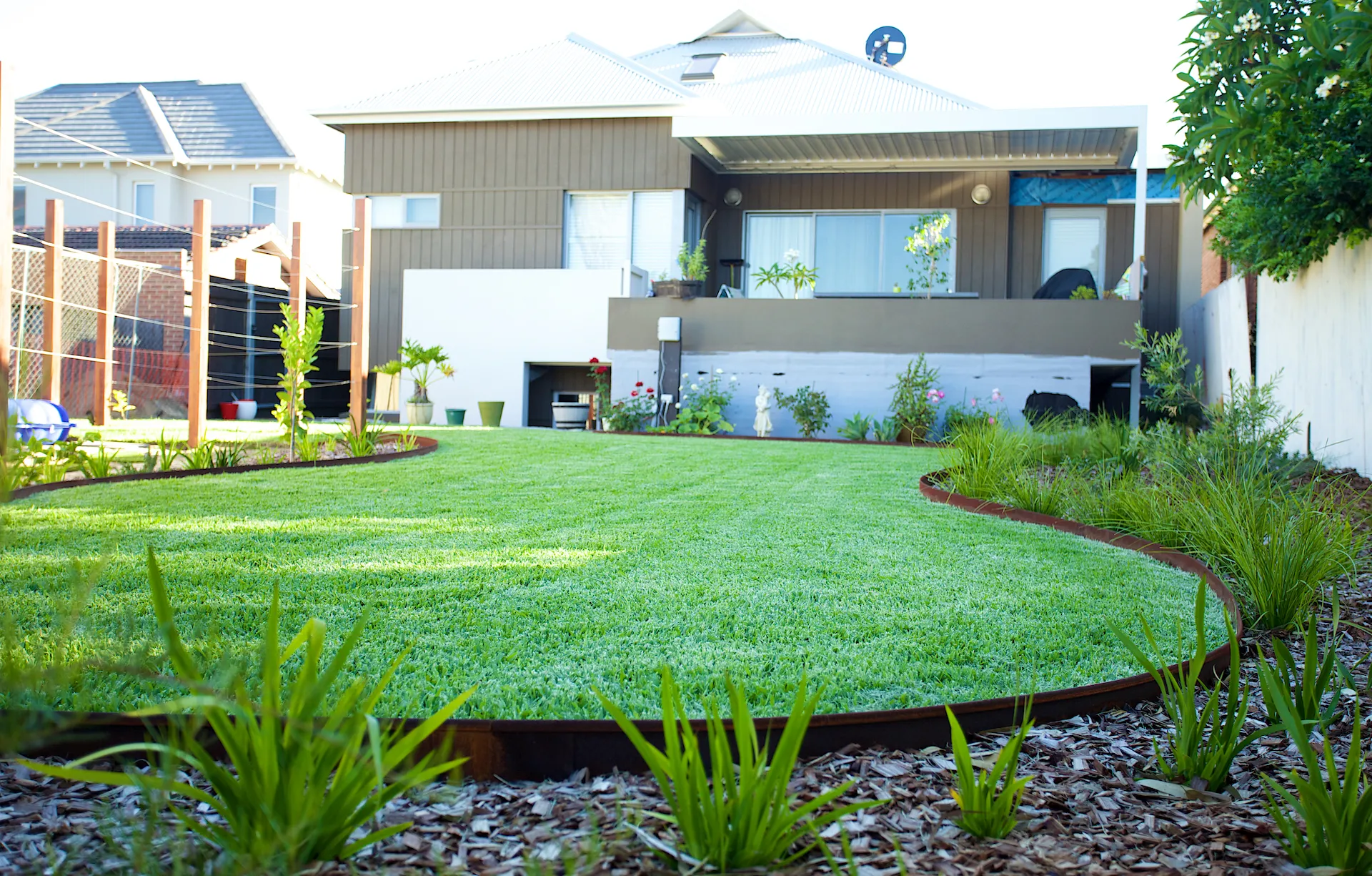 Custom backyard landscape project with new lawn and garden beds, Perth
